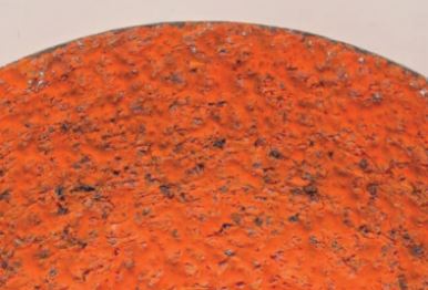 Figure 2:  6.5 PSI of force was applied for 2:24 minutes, removing 55 grams. Notice the gleaming areas along the edges. Because of the lower force used, metal fines cap the grain, also known as metal capping.